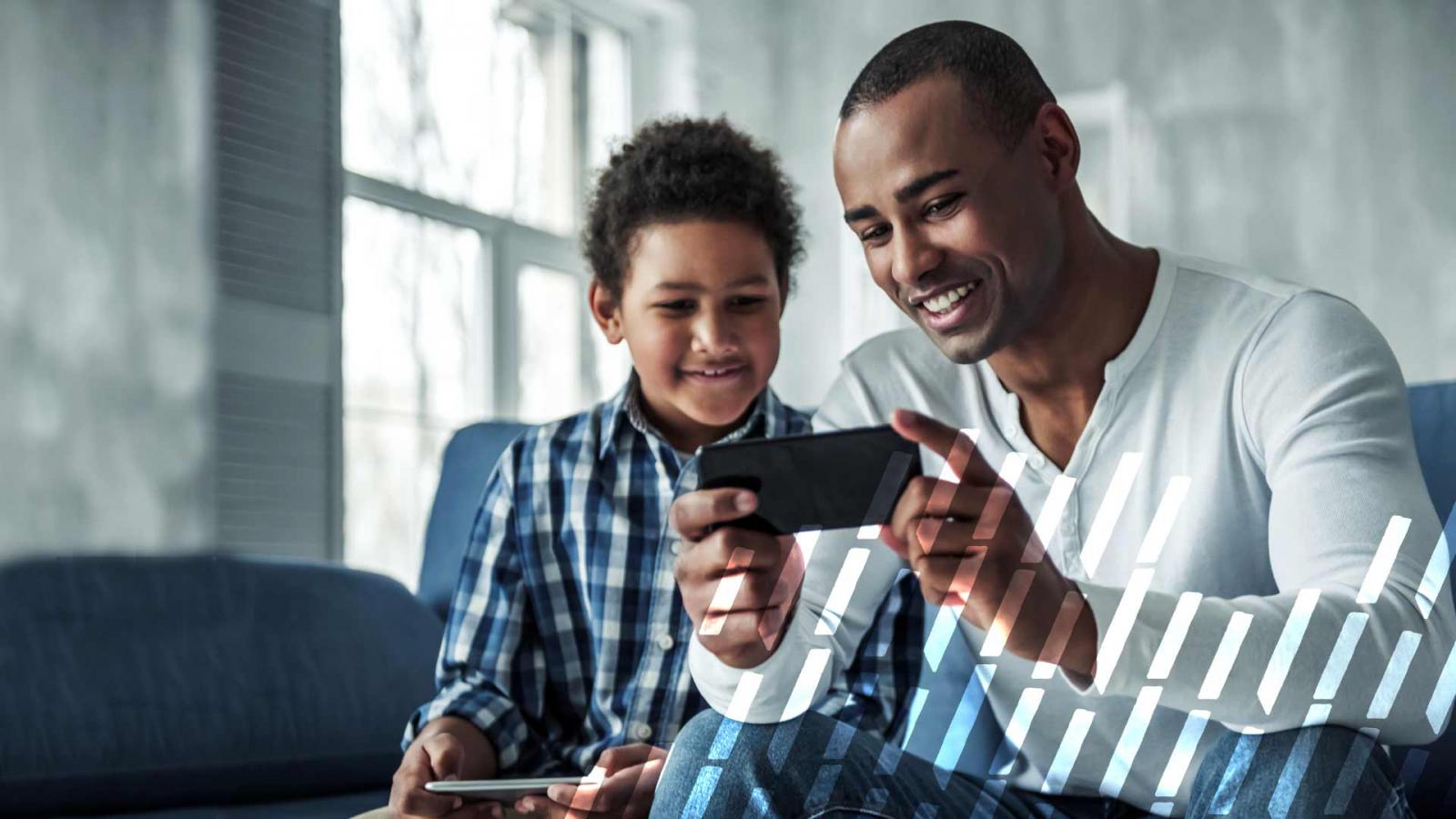 Father and son smiling at a phone